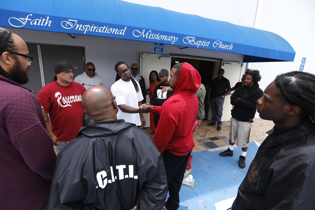 Leaders of gangs affiliated with the notorious Bloods and Crips wish each other well after a cease-fire summit held at Compton's Faith Inspirational Missionary Baptist Church in April 2019. The rivals have been inspired to come together in the aftermath of South L.A. rapper Nipsey Hussle's death in March. (Credit: Genaro Molina / Los Angeles Times)