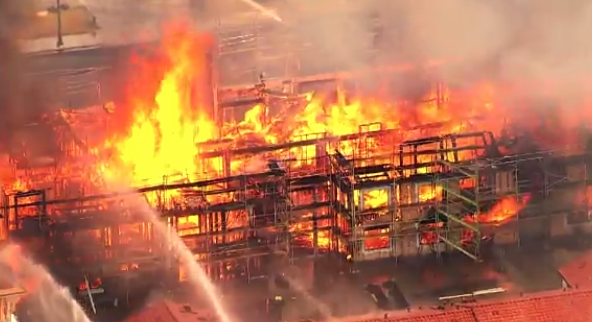 Firefighters battle a fire engulfing a condominium complex under construction in Santa Clara County on June 28, 2019. (Credit: KGO via CNN)