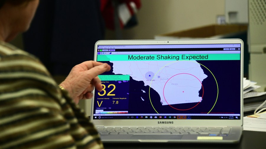 In this file photo, Margaret Vinci, manager of the Seismological Laboratory at Caltech points to a shake alert user display on a laptop screen, set for a limited release on June 1, 2017, at the Caltech Seismological Laboratory in Pasadena. (FREDERIC J. BROWN/AFP/Getty Images)