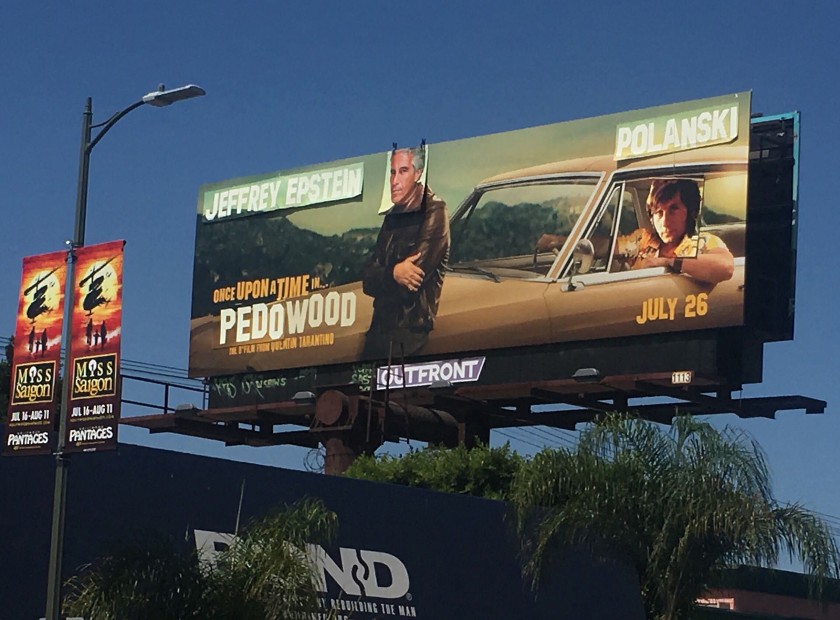 A “Once Upon a Time ... in Hollywood” movie billboard on the south side of Pico at Alfred Street, one block east of La Cienega, is altered to show Jeffrey Epstein’s and director Roman Polanski’s face over actors Leonardo DiCaprio and Brad Pitt.(Credit: Jen Yamato / Los Angeles Times)