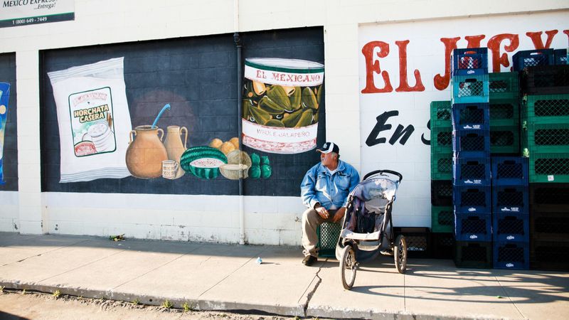 An undated image shows a man sitting outside a grocery store in Firebaugh, a rural farming community with a population of about 7,000 people, has struggled with higher unemployment than many other parts of California. (Credit: Bethany Mollenkof / Los Angeles Times)