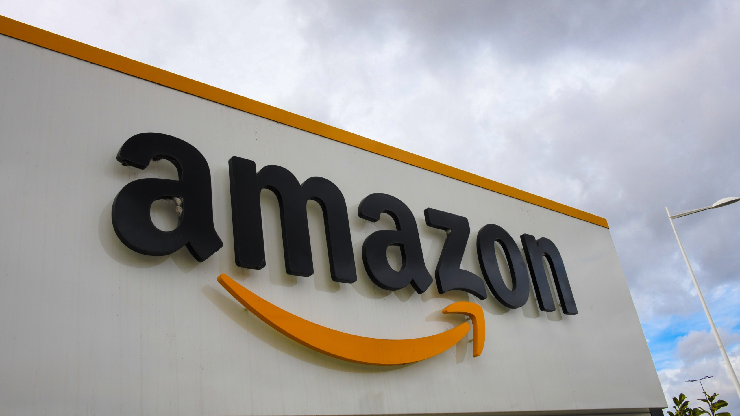 A picture shows the Amazon logo at the entrance area of the Amazon logistics centre in Lauwin-Planque, northern France, on March 4, 2019. (Credit: DENIS CHARLET / AFP/Getty Images)