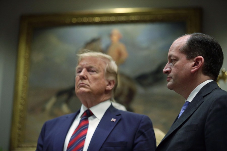 Donald Trump and Secretary of Labor Alexander Acosta listen during a Roosevelt Room event at the White House on May 9, 2019. (Credit: Alex Wong/Getty Images)