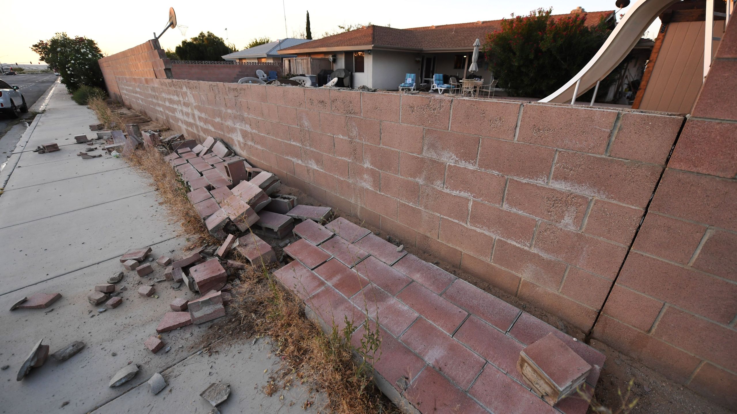 A cinderblock wall partially destroyed in Ridgecrest on July 6, 2019, following a magnitude 7.1 earthquake the previous night. (Credit: ROBYN BECK/AFP/Getty Images)