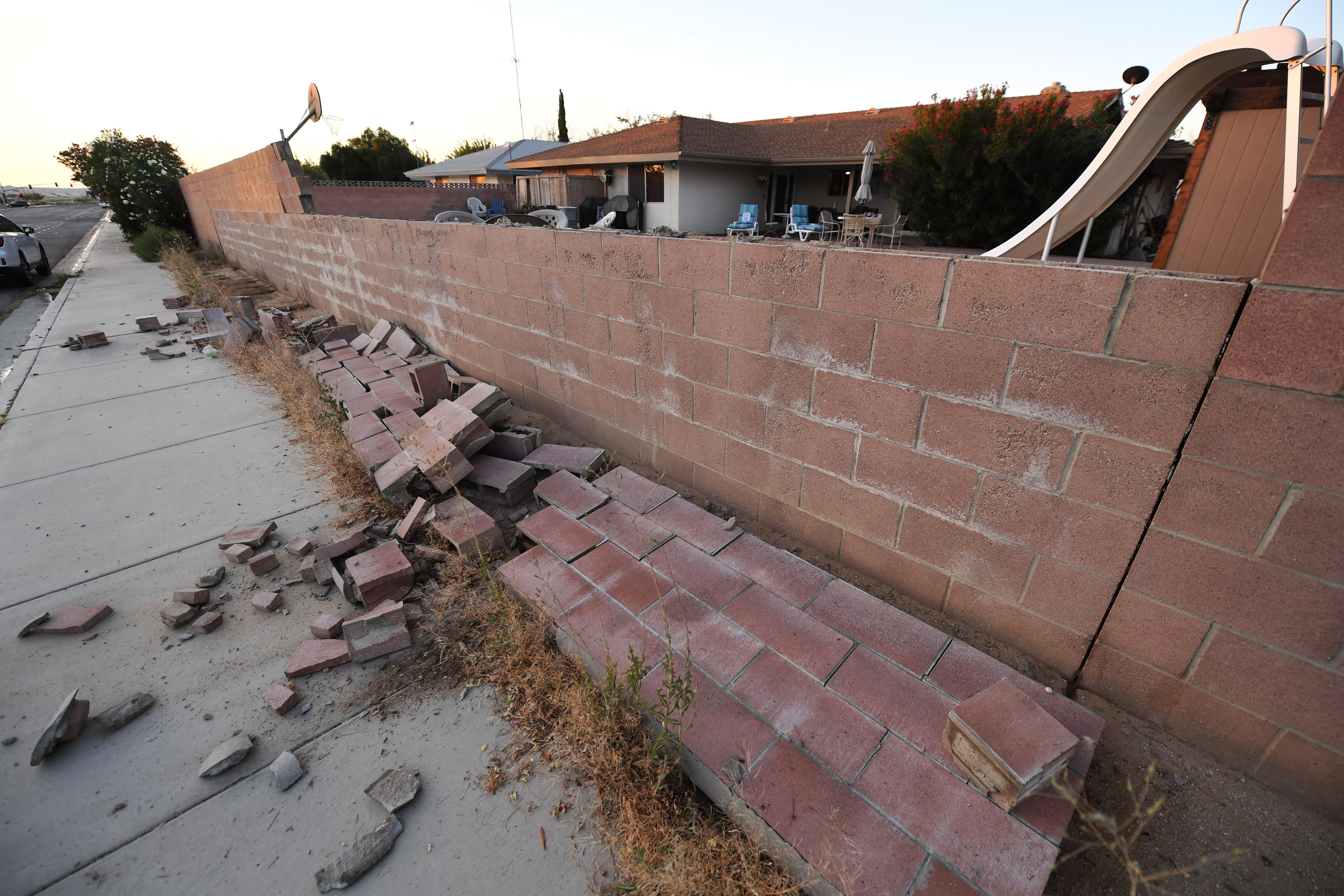 A cinderblock wall partially destroyed in Ridgecrest on July 6, 2019, following a magnitude 7.1 earthquake the previous night. (Credit: ROBYN BECK/AFP/Getty Images)