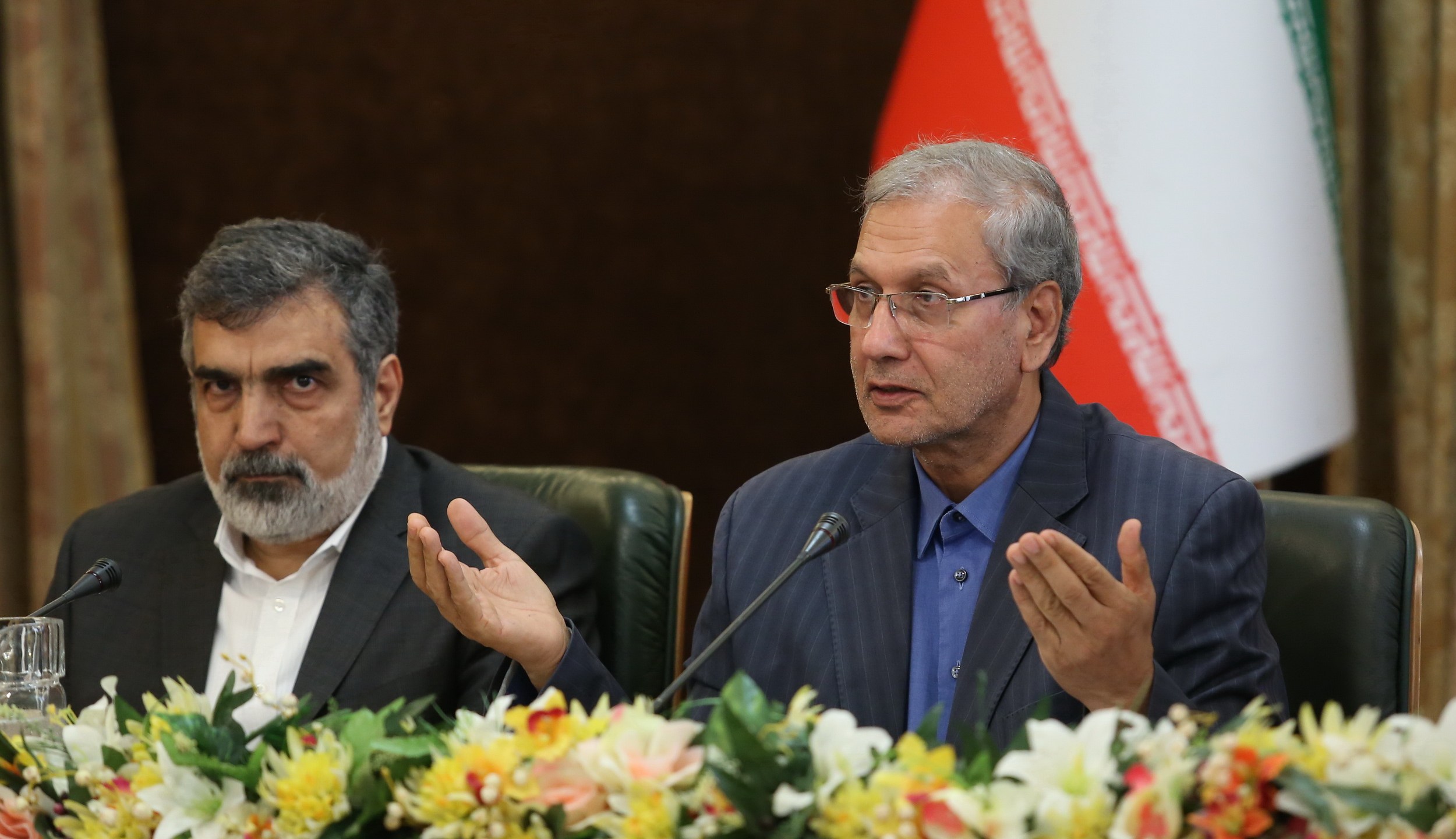 A handout picture provided by the Iranian presidency on July 7, 2019 shows (left to right) Iran's Atomic Energy Organization spokesman Behrouz Kamalvandi and government spokesman Ali Rabiei giving a joint press conference at the presidential headquarters in Tehran. (Credit: AFP/Getty Images)