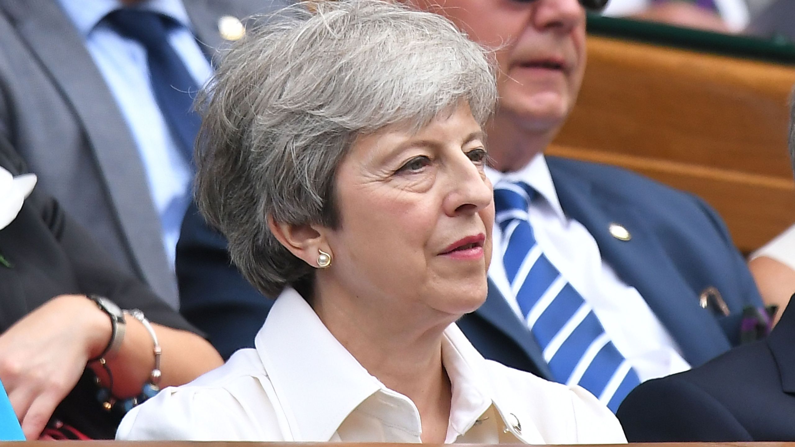 Britain's Prime Minister Theresa May sits in the Royal Box on Centre Court to watch Romania's Simona Halep playing U.S. player Serena Williams during their women's singles final on day twelve of the 2019 Wimbledon Championships at The All England Lawn Tennis Club in Wimbledon, southwest London, on July 13, 2019. (Credit: BEN STANSALL/AFP/Getty Images)