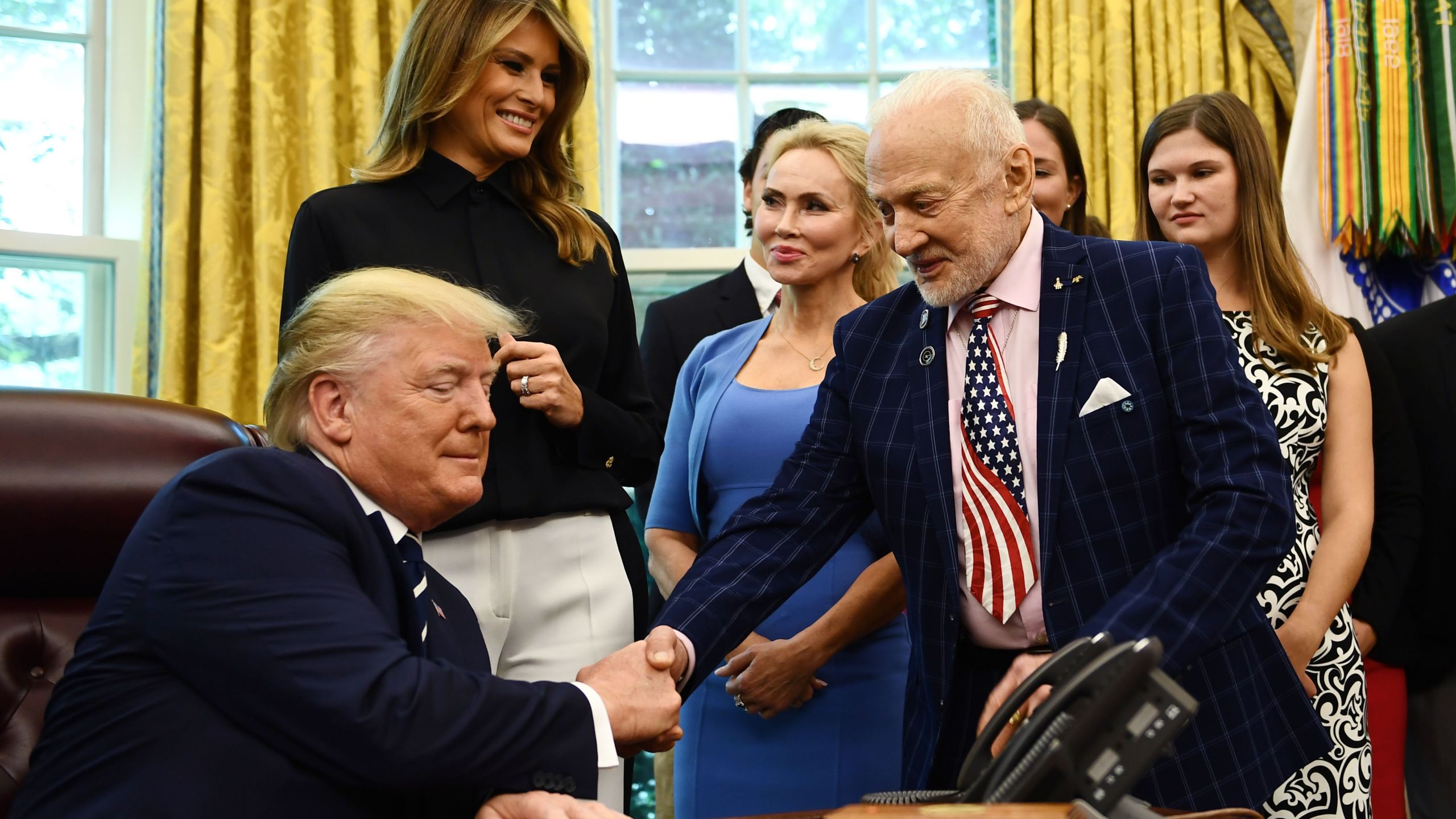 U.S. President Donald Trump shakes hands with Apollo 11 crew member Buzz Aldrin on July 19, 2019, at the White House in Washington, D.C., during a ceremony commemorating the 50th anniversary of the Moon landing. (Credit: Brendan Smialowski / AFP/ Getty Images)