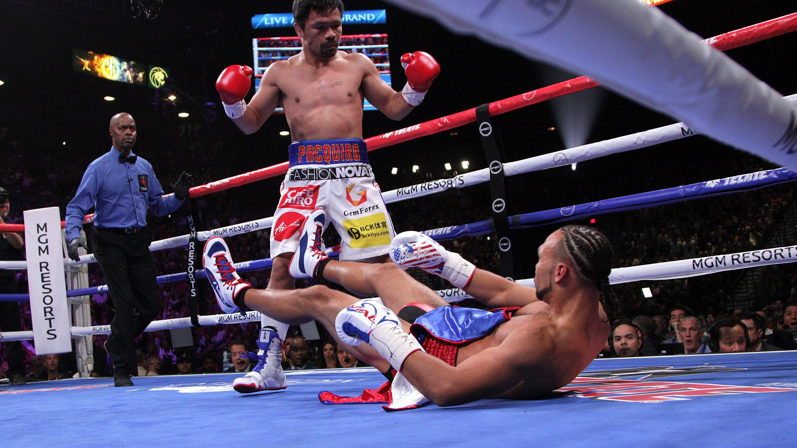 Manny Pacquiao sends Keith Thurman to the mat during the first round of their WBA super world welterweight title fight at the MGM Grand Garden Arena on July 20, 2019 in Las Vegas, Nevada. (Credit: JOHN GURZINSKI/AFP/Getty Images)