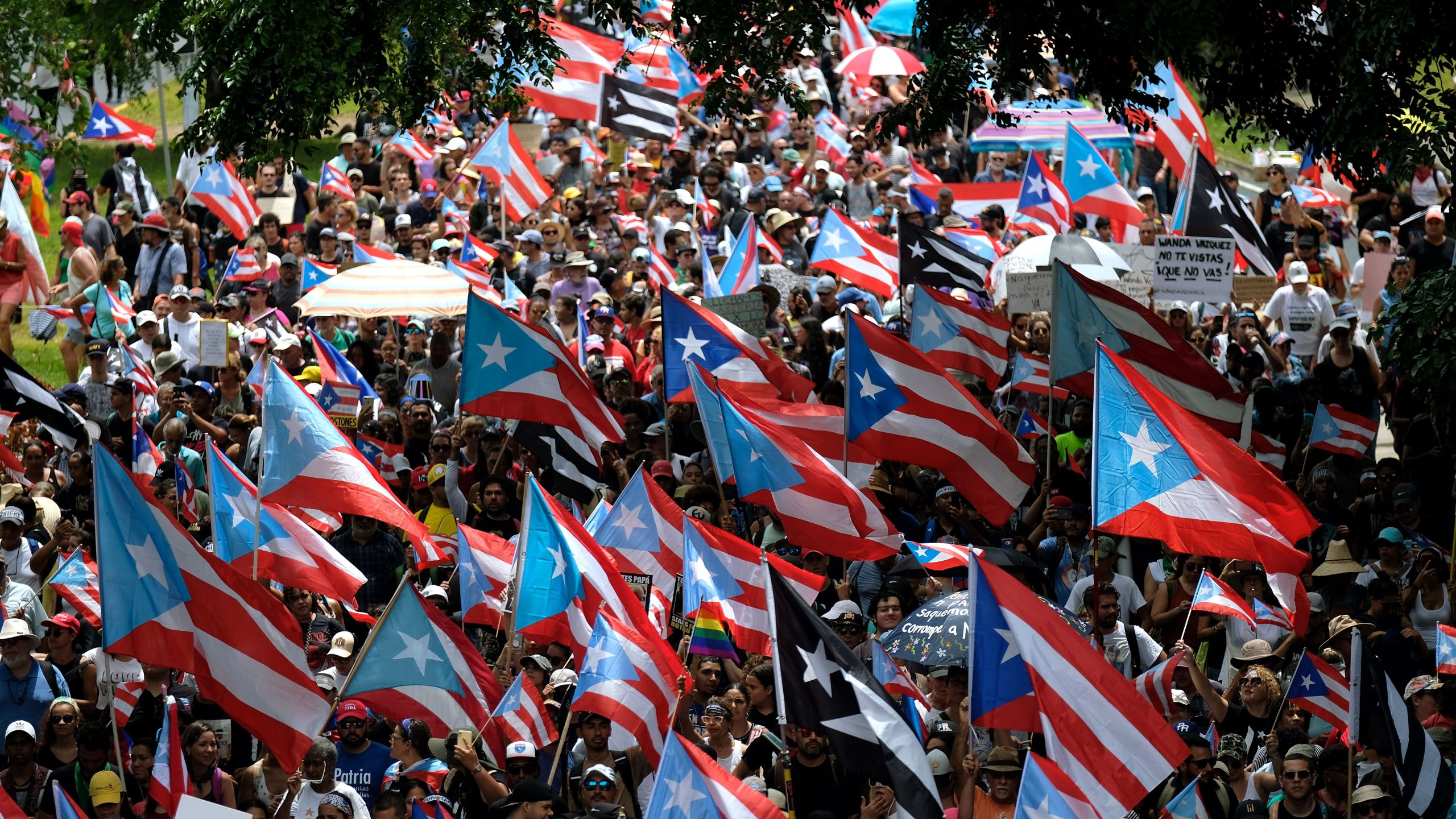 People march in San Juan on July 25, 2019, one day after the resignation of Puerto Rico Gov. Ricardo Rossello. (Credit: RICARDO ARDUENGO/AFP/Getty Images)