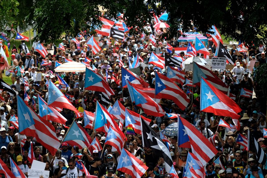 People march in San Juan on July 25, 2019, one day after the resignation of Puerto Rico Gov. Ricardo Rossello. (Credit: RICARDO ARDUENGO/AFP/Getty Images)