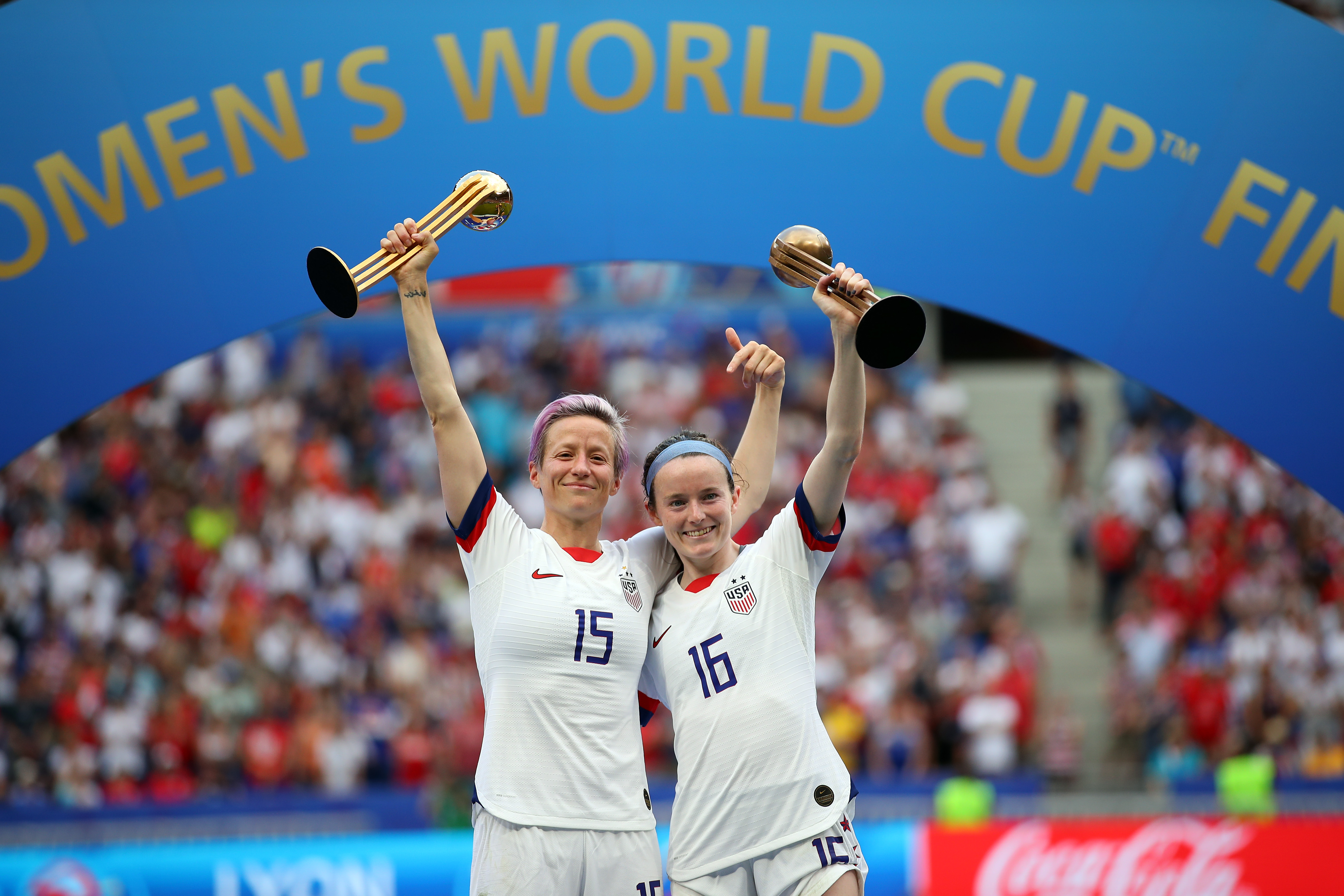 Megan Rapinoe of team USA celebrates with the Golden Ball award and teammate Rose Lavelle celebrates with the Bronze Ball award following the 2019 FIFA Women's World Cup France Final match at Stade de Lyon on July 7, 2019 in Lyon, France. (Credit: Richard Heathcote/Getty Images)