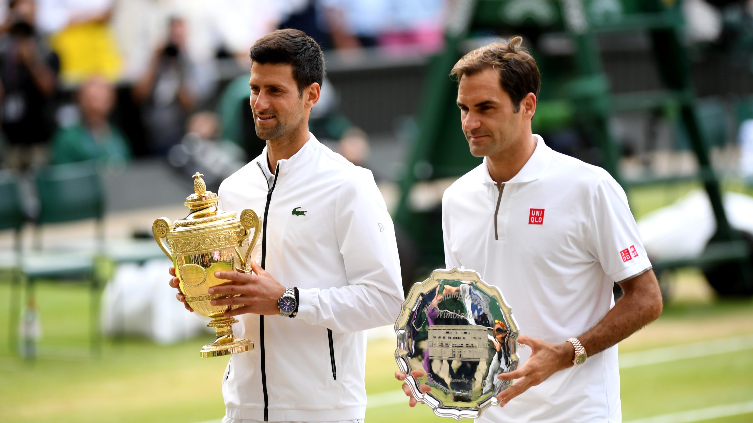 Novak Djokovic of Serbia and Roger Federer of Switzerland pose for a photo with their trophies after Men's Singles final against Roger Federer of Switzerland during Day 13 of The Championships - Wimbledon 2019 at All England Lawn Tennis and Croquet Club on July 14, 2019 in London, England. (Credit: Matthias Hangst/Getty Images)