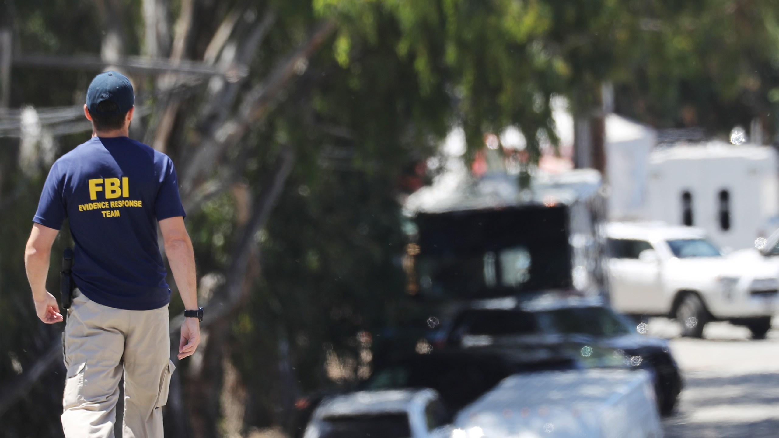 An FBI agent walks toward the site of the Gilroy Garlic Festival after a mass shooting took place there yesterday on July 29, 2019 in Gilroy, California. (Credit: Mario Tama/Getty Images)