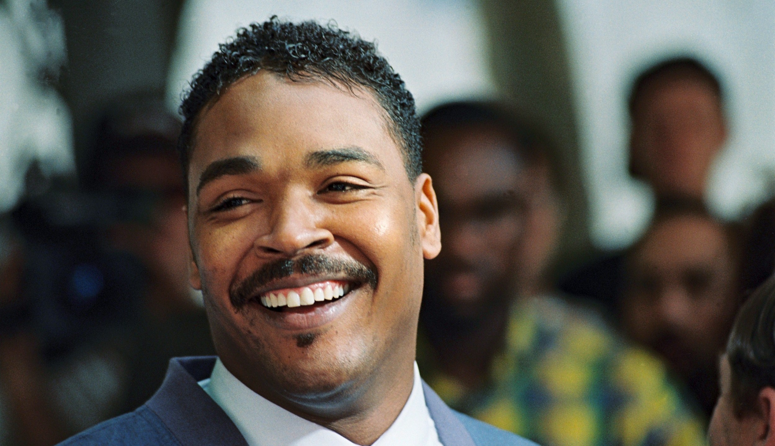 Rodney King, the Los Angeles motorist whose beating by police was captured on videotape, smiles during a press conference where he called for the end of violence in the city on May 1, 1992, in Beverly Hills. (Credit: Robert Sullivan / AFP / Getty Images)