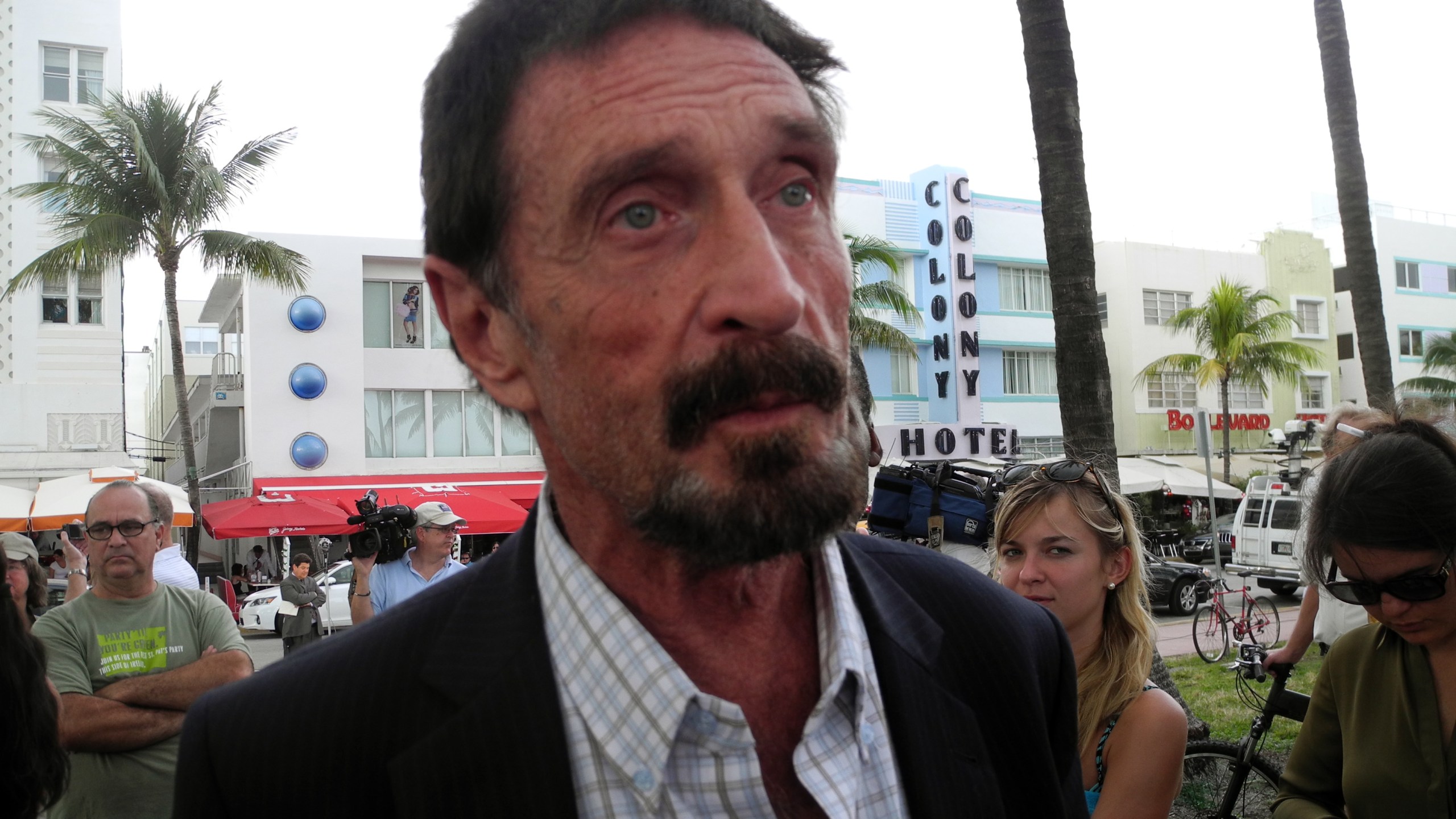 Software company founder John McAfee speaks in front of this hotel in Miami Beach, Florida on December 13, 2012, a day after being deported to US from Guatemala, where was detained for immigration violations. (Credit: PAULA BUSTAMANTE/AFP/Getty Images)