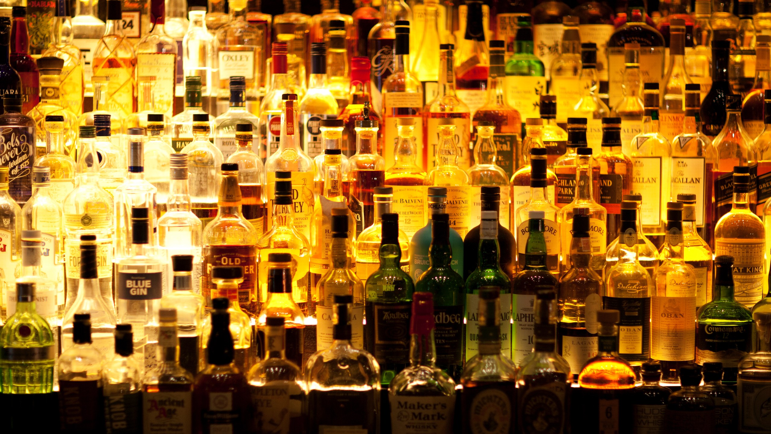 Various liquor bottles are pictured behind a bar in this undated image.