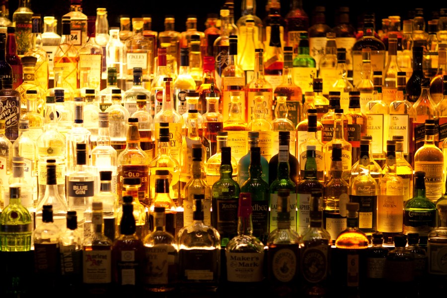 Various liquor bottles are pictured behind a bar in this undated image.