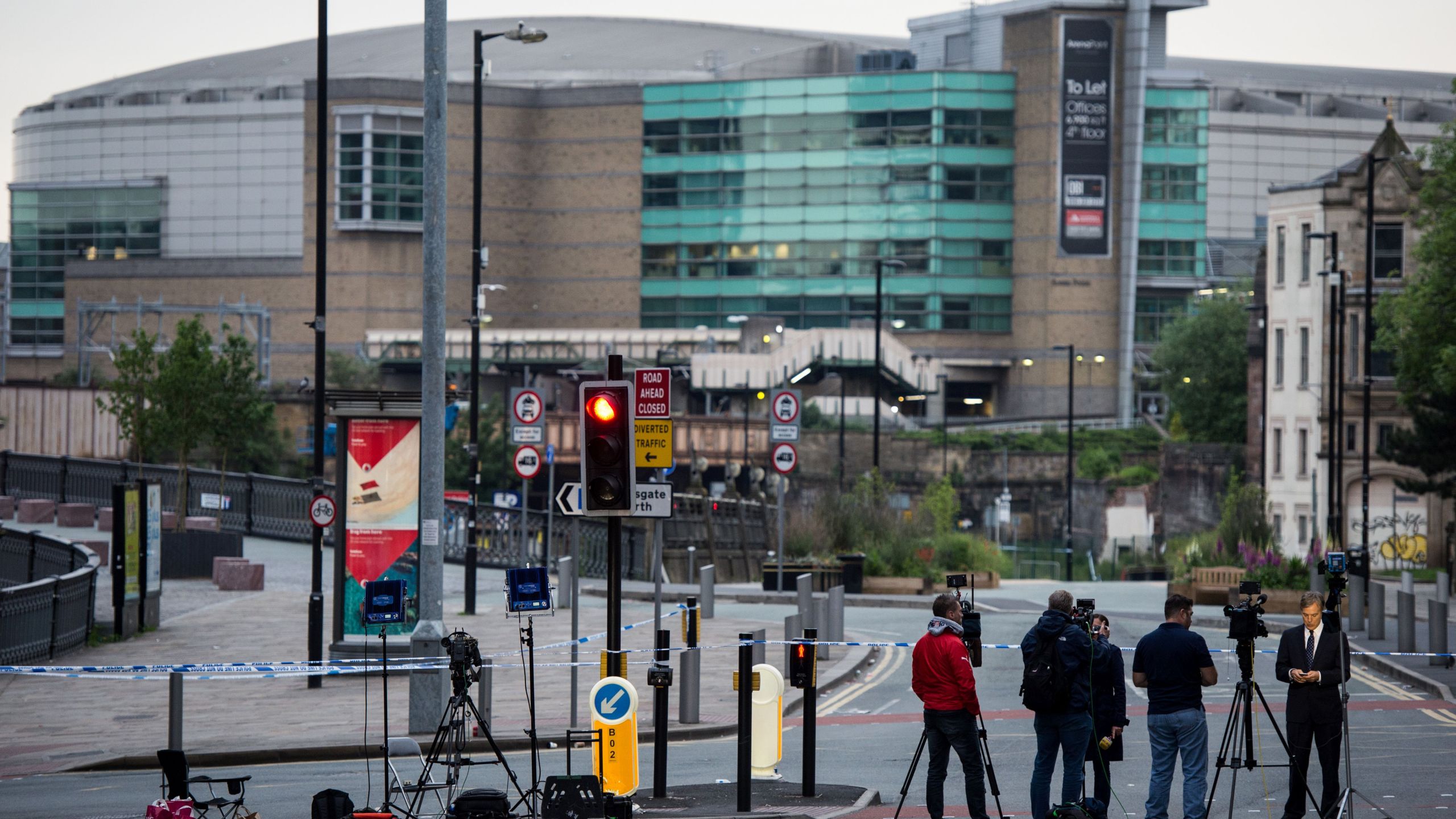 Journalists and television cameras stand by a police cordon near to the Manchester Arena in Manchester, northwest England on May 24, 2017, following the May 22 terror attack at the Manchester Arena. (Credit: CHRIS J RATCLIFFE/AFP/Getty Images)