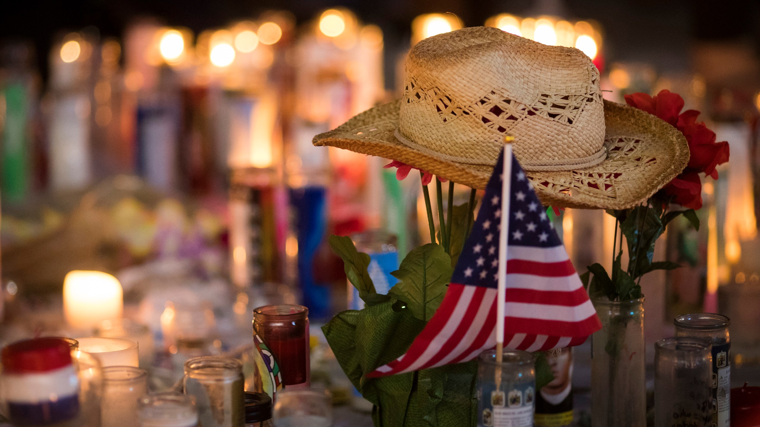 A hat is left at a makeshift memorial during a vigil to mark one week since the mass shooting at the Route 91 Harvest country music festival in Las Vegas, Nevada. (Credit: Drew Angerer/Getty Images)