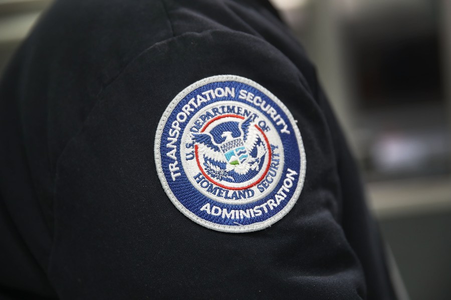 A patch is seen on the jacket of a Transportation Security Administration official as he works at the automated screening lanes funded by American Airlines and installed by the Transportation Security Administration at Miami International Airport on October 24, 2017 in Miami, Florida. (Credit: Joe Raedle/Getty Images)