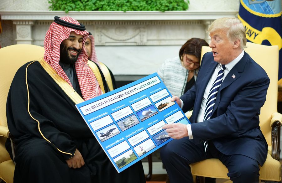 Donald Trump looks at a defense sales chart with Saudi Arabia's Crown Prince Mohammed bin Salman in the Oval Office of the White House on March 20, 2018 in Washington, DC. (Credit: MANDEL NGAN/AFP/Getty Images)