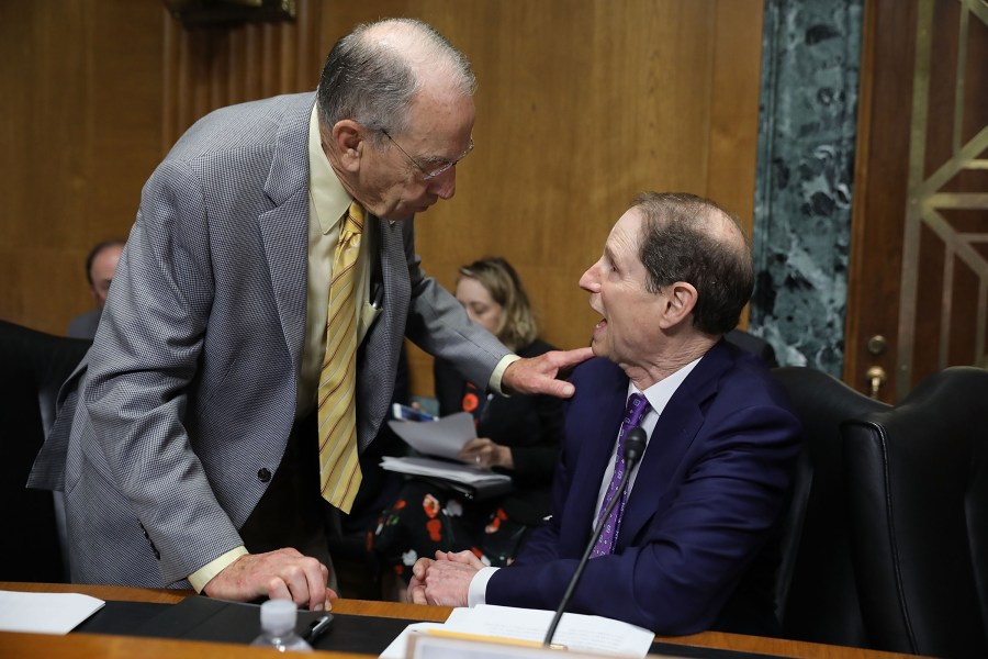 Senate Finance Committee member Sen. Charles Grassley (R-IA) (L) talks with committee ranking member Sen. Ron Wyden (D-OR) before a hearing with U.S. Secretary of Commerce Wilbur Ross in the Dirksen Senate Office Building on Capitol Hill June 20, 2018 in Washington, DC. (Credit: Chip Somodevilla/Getty Images)