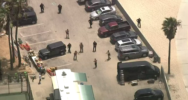 Office surround the driver at a Venice Beach Board Walk parking lot following a pursuit on July 12, 2019. (Credit: KTLA)