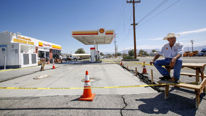 Roger Sandoval sits on a table at his Shell gas station in Trona, which suffered major damage to its holding tanks in the July 5, 2019 7.1 magnitude quake that struck in the Mojave Desert. (Credit: Irfan Khan / Los Angeles Times)