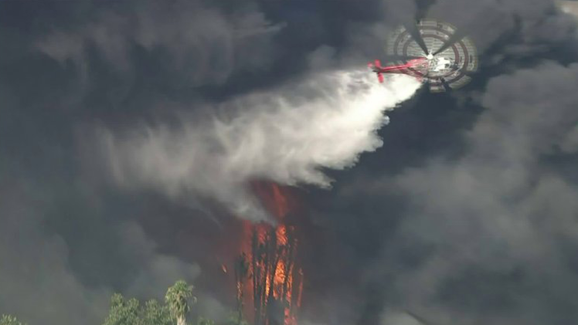 Fire crews drop water on a brush fire in the Sepulveda Basin area on July 30, 2019. (Credit: KTLA)