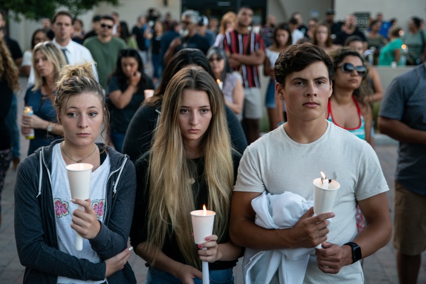 Mourners are seen during a candlelight vigil at Gilroy City Hall. (Credit: Kent Nishimura/Los Angeles Times)