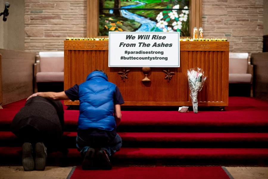 Mourners pray during a vigil for Camp Fire victims at the First Christian Church of Chico on Nov. 18, 2018, in Chico, Calif. (Credit: Noah Berger-Pool/Getty Images)