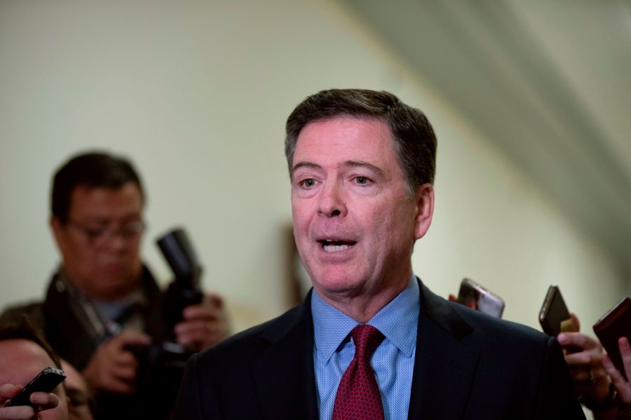 Former FBI Director James Comey (C) talks to reporters following a closed House Judiciary Committee meeting to hear his testimony, on Capitol Hill in Washington, DC, on December 7, 2018. (Credit: ALEX EDELMAN/AFP/Getty Images)