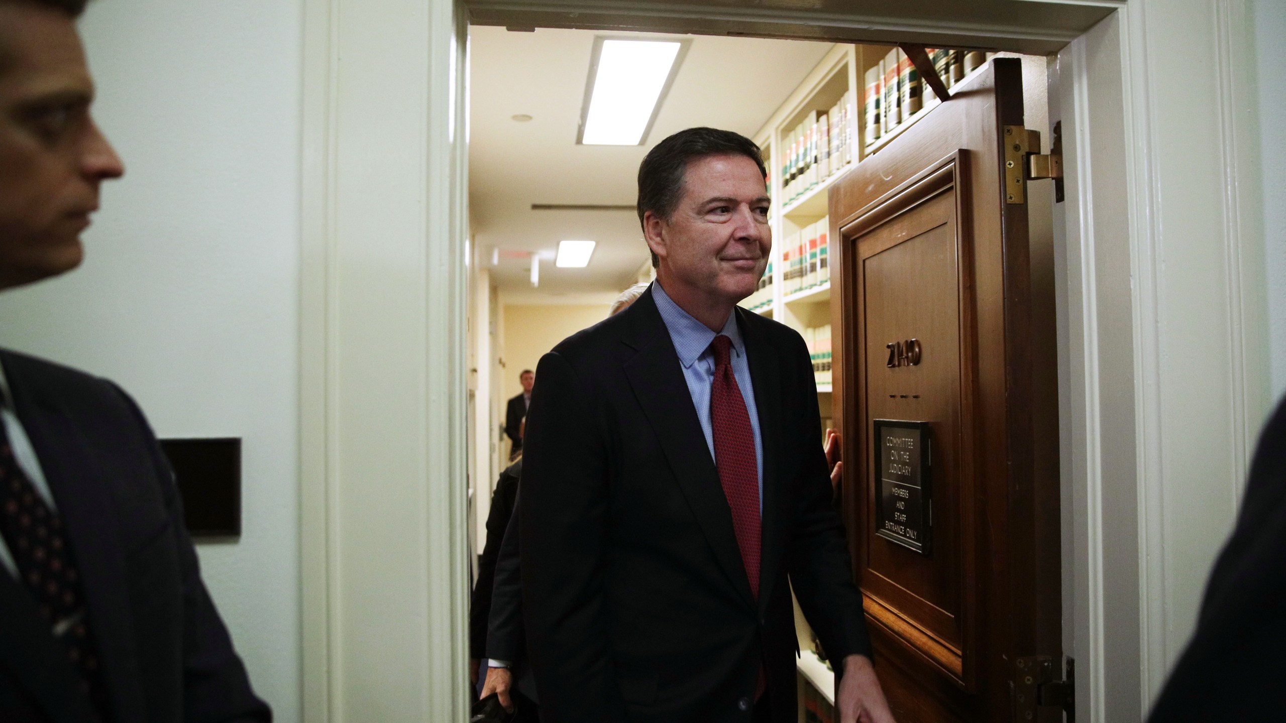 James Comey comes out of the hearing room at the Rayburn House Office Building after testifying to the House Judiciary and Oversight and Government Reform committees on Capitol Hill Dec. 7, 2018 in Washington, D.C. (Credit: Alex Wong/Getty Images)