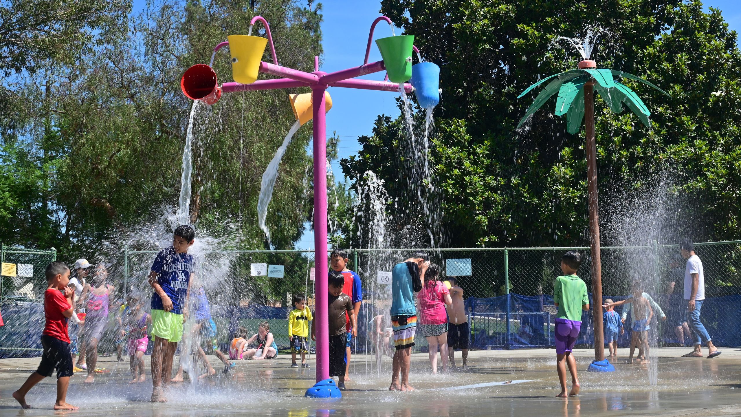 Children cool off at a water park in Alhambra on July 27, 2019. (Credit: FREDERIC J. BROWN/AFP/Getty Images)