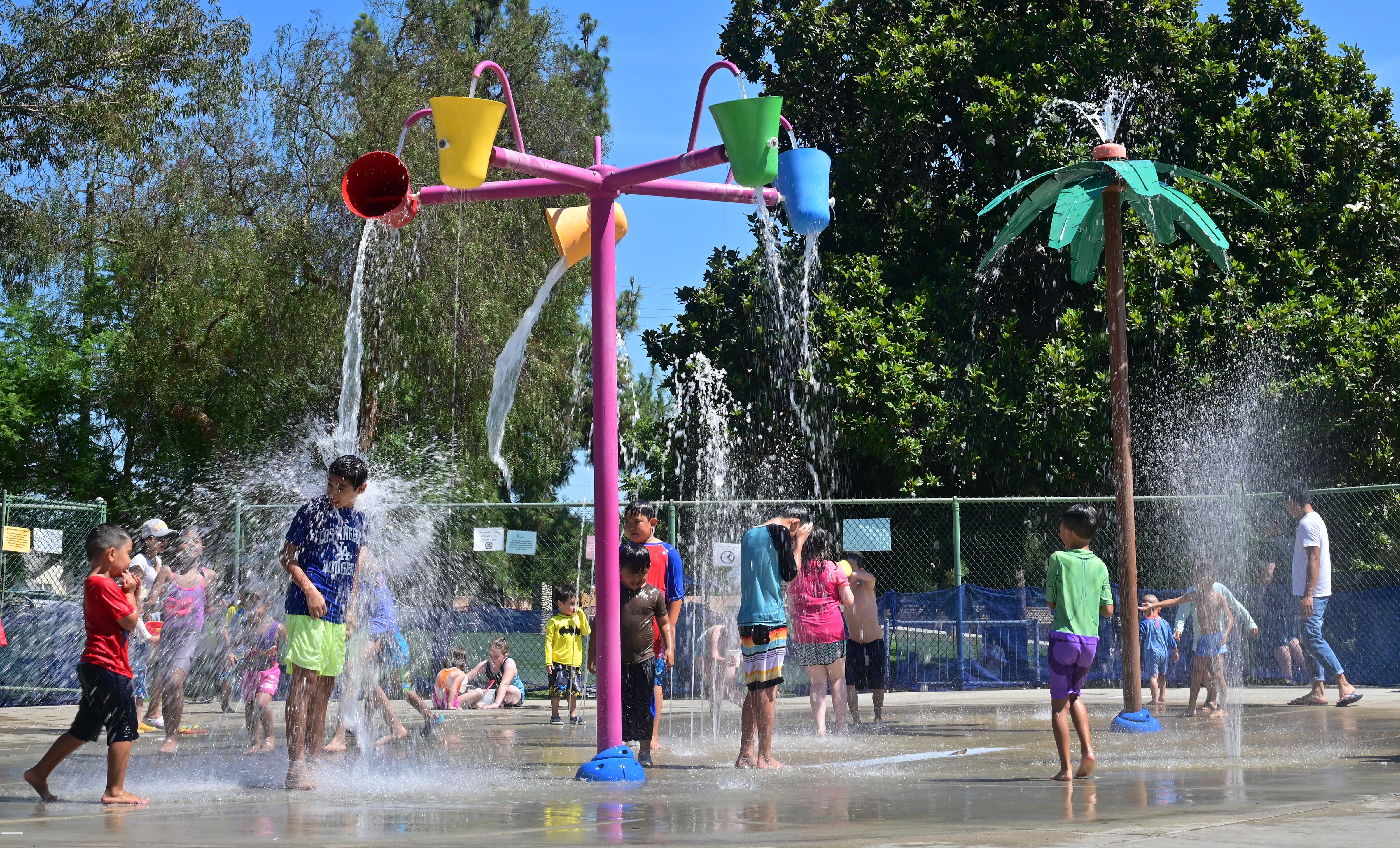 Children cool off at a water park in Alhambra on July 27, 2019. (Credit: FREDERIC J. BROWN/AFP/Getty Images)