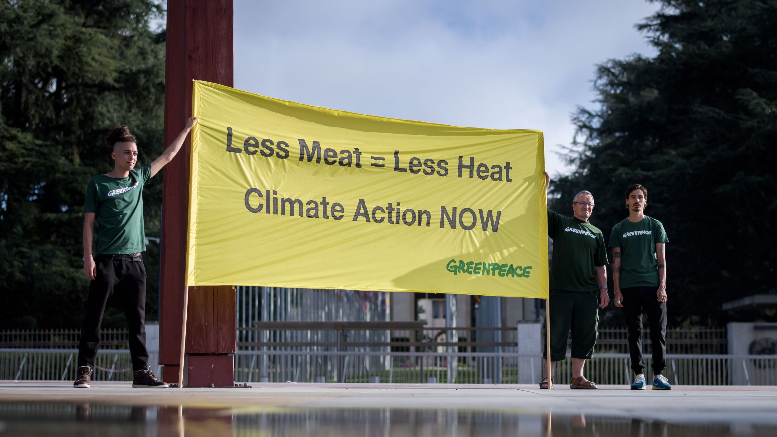 Greenpeace activists hold a banner during a protest prior to the publication by The UN's Intergovernmental Panel on Climate Change (IPCC) of a special report on climate change and land on Aug. 8, 2019, in Geneva. (Credit: FABRICE COFFRINI/AFP/Getty Images)