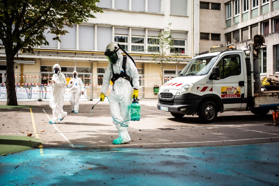 A worker sprays a gel on the ground to absorb lead as he takes part in a clean-up operation at Saint Benoit school near Notre-Dame cathedral in Paris during a decontamination work on Aug. 8, 2019. (Credit: MARTIN BUREAU/AFP/Getty Images)