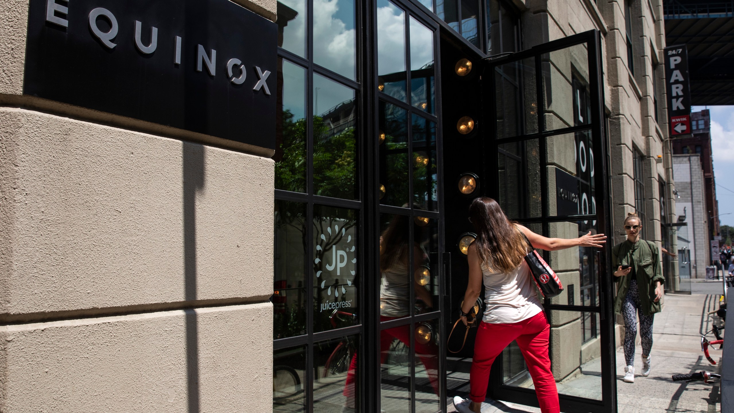 A customer enters an Equinox fitness center on Aug. 8, 2019, in the Brooklyn borough of New York City. (Credit: Drew Angerer/Getty Images)