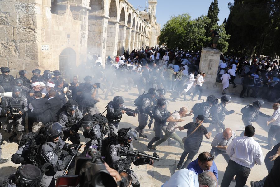 Israeli security forces fire sound grenades inside the Al-Aqsa Mosque compound in the Old City of Jerusalem on August 11, 2019, as clashes broke out during the overlapping Jewish and Muslim holidays of Eid al-Adha and the Tisha B'av holdiay inside the hisotric compound which is considered the third-holiest site in Islam and the most sacred for Jews, who revere it as the location of the two biblical-era temples. (Credit: AHMAD GHARABLI/AFP/Getty Images)