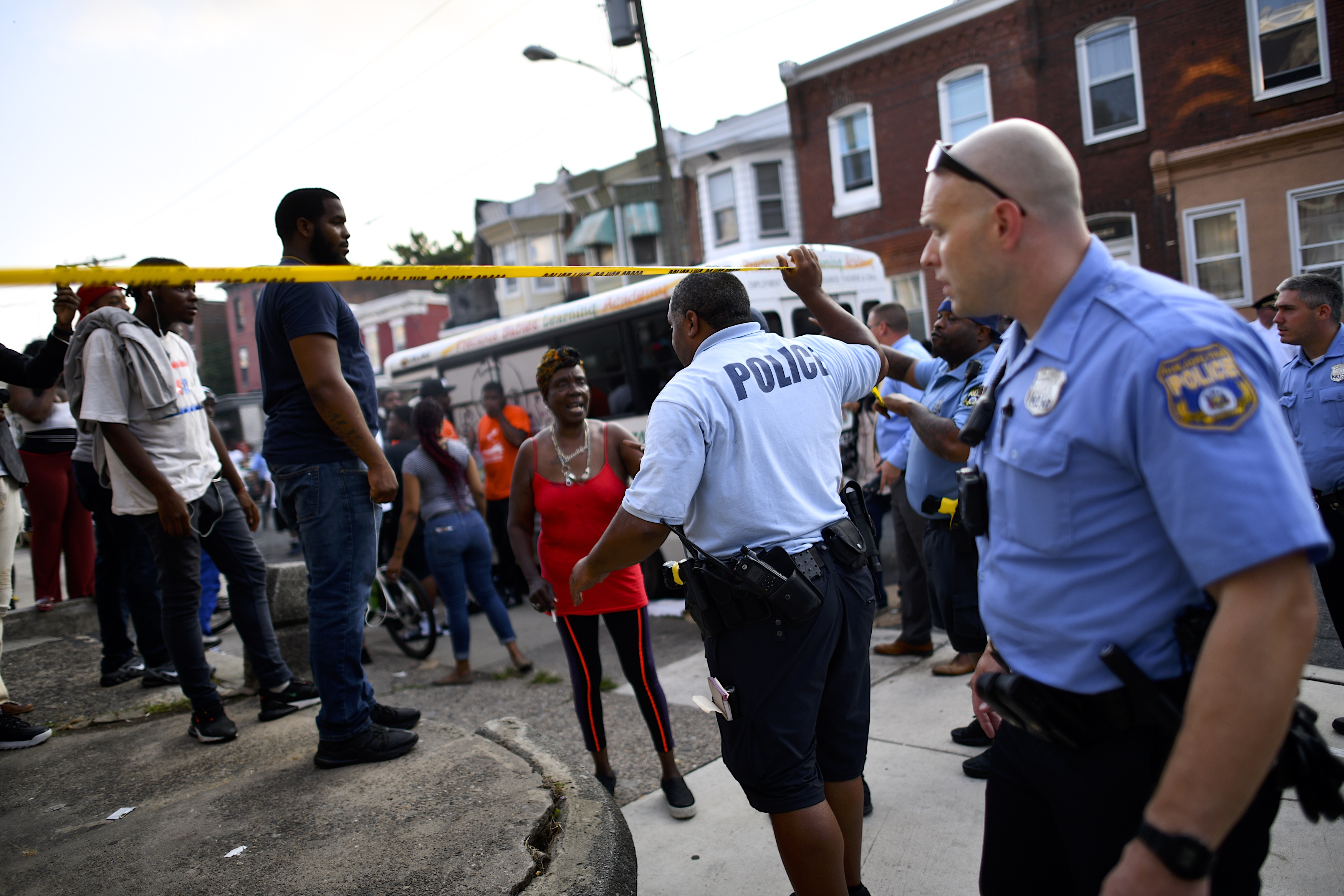 Police officers direct citizens to move back near the scene of a shooting in Philadelphia on Aug. 14, 2019. (Credit: Mark Makela / Getty Images)