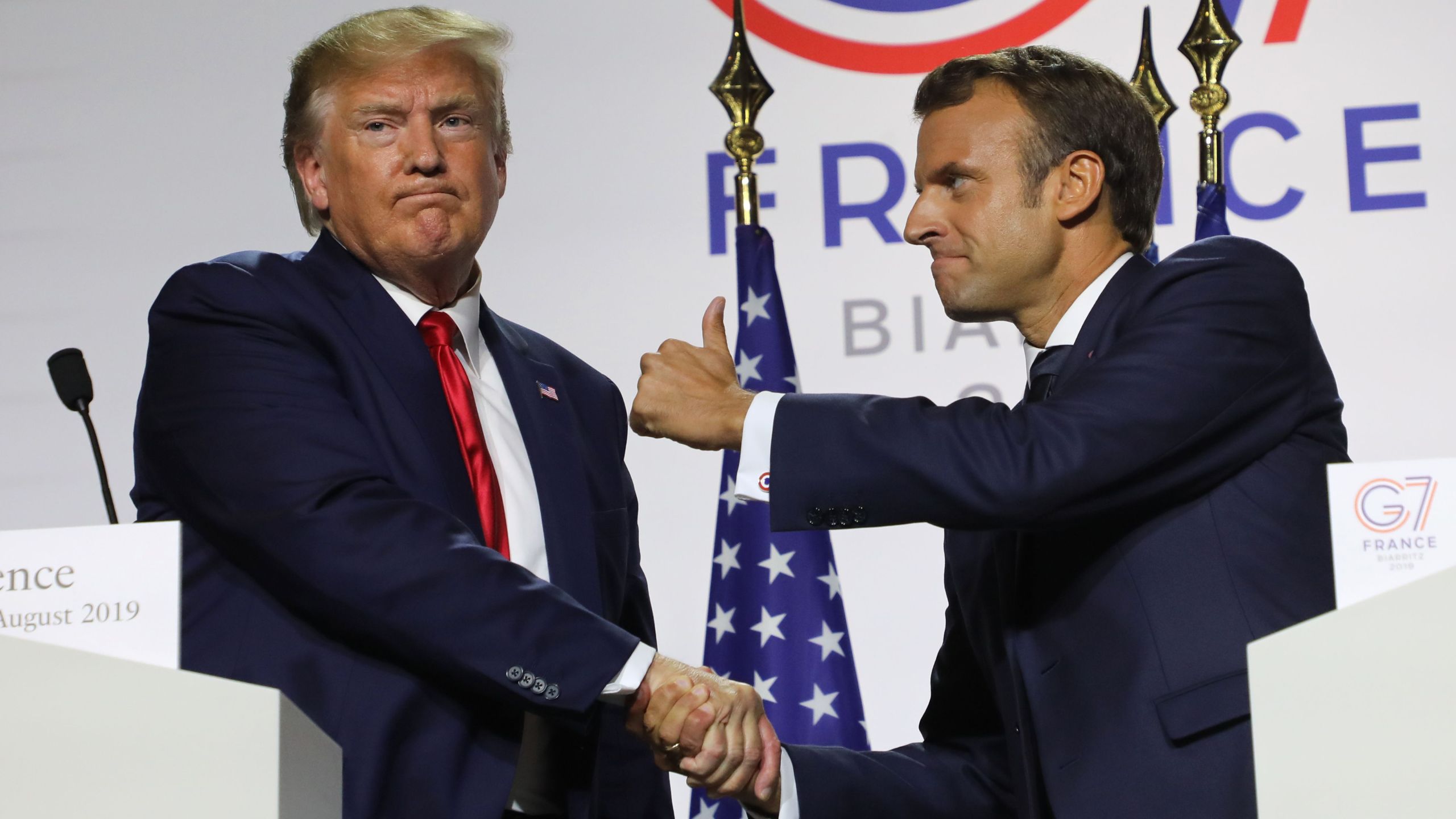 France's President Emmanuel Macron (R) and U.S. President Donald Trump shake hands during a joint-press conference in Biarritz, south-west France on August 26, 2019, on the third day of the annual G7 Summit attended by the leaders of the world's seven richest democracies, Britain, Canada, France, Germany, Italy, Japan and the United States. (Photo by ludovic MARIN / AFP) (Credit: LUDOVIC MARIN/AFP/Getty Images)