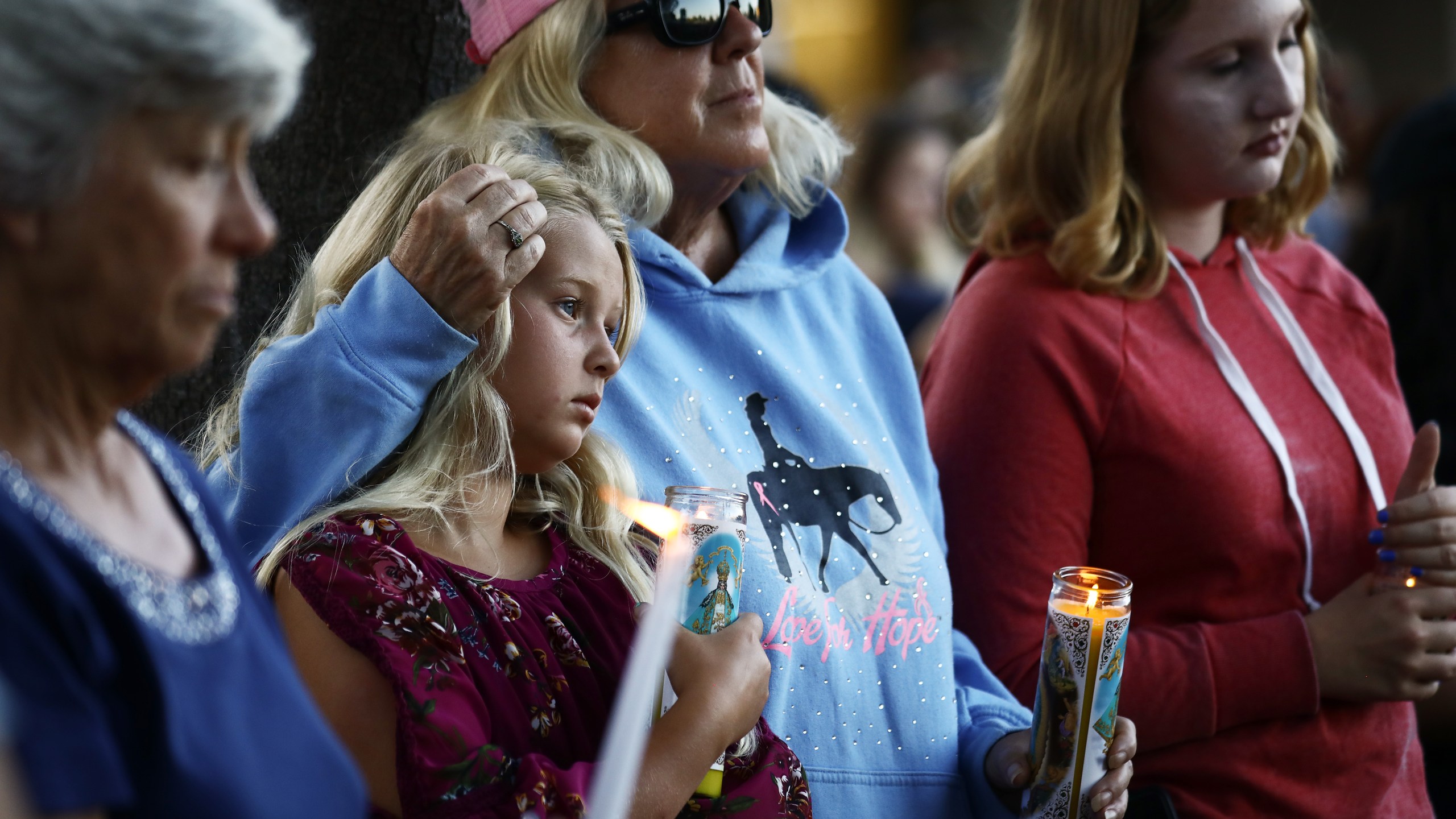 People attend a vigil in Gilroy for victims of the mass shooting at the garlic festival, July 29, 2019. (Credit: Mario Tama / Getty Images)