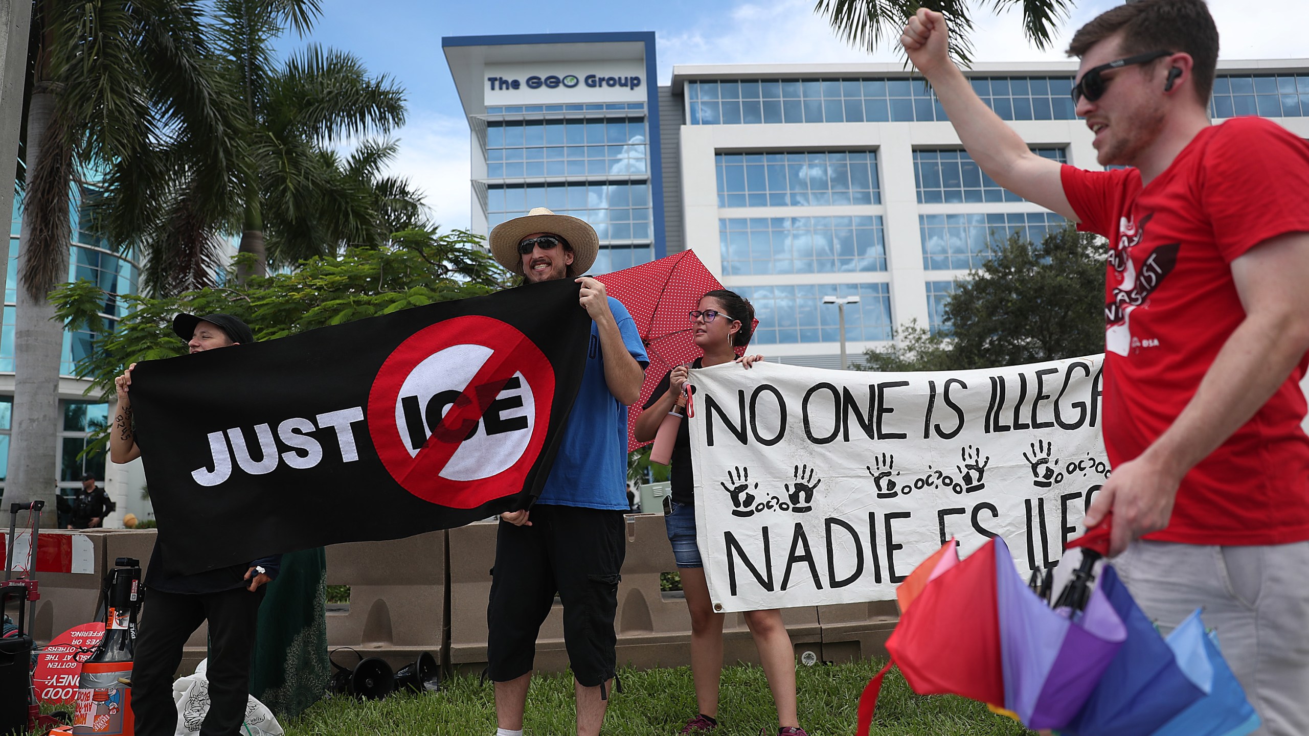 Activists and protesters including the group Never Again Action are seen as they protest outside the headquarters of the private prison company Geo Group on Aug. 12, 2019, in Boca Raton, Fla. (Credit: Joe Raedle/Getty Images)