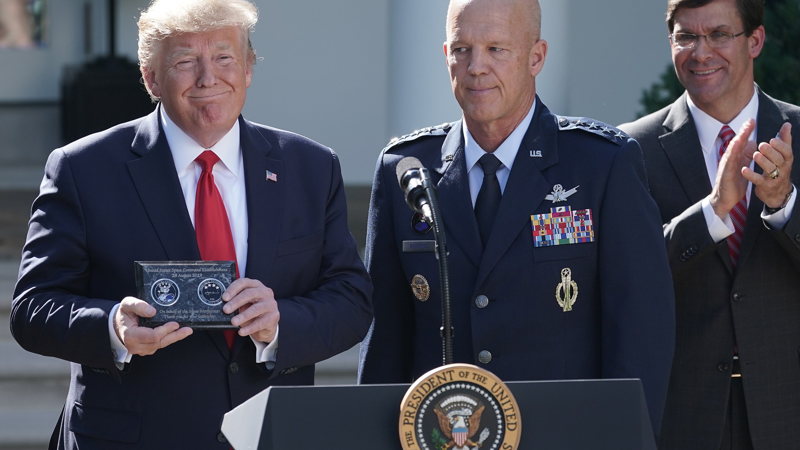 From left: President Donald Trump, Air Force Gen. John "Jay" Raymond and Defense Secretary Mark Esper attend an event marking the establishment the U.S. Space Command, the sixth national armed service, in the Rose Garden at the White House Aug. 29, 2019. (Credit: Chip Somodevilla / Getty Images)