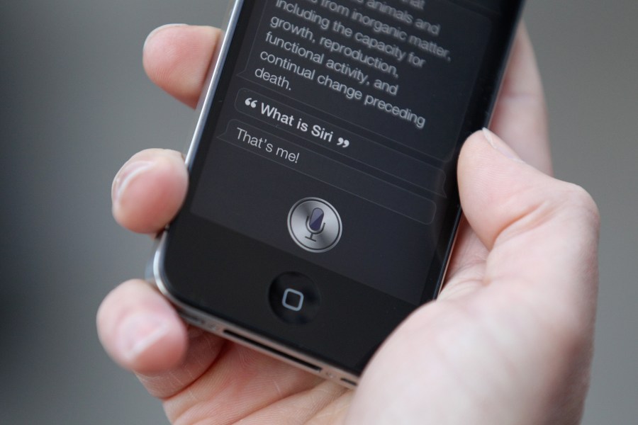 A man uses 'Siri' on the iPhone 4S on Oct. 14, 2011, in London, England. (Credit: Oli Scarff/Getty Images)