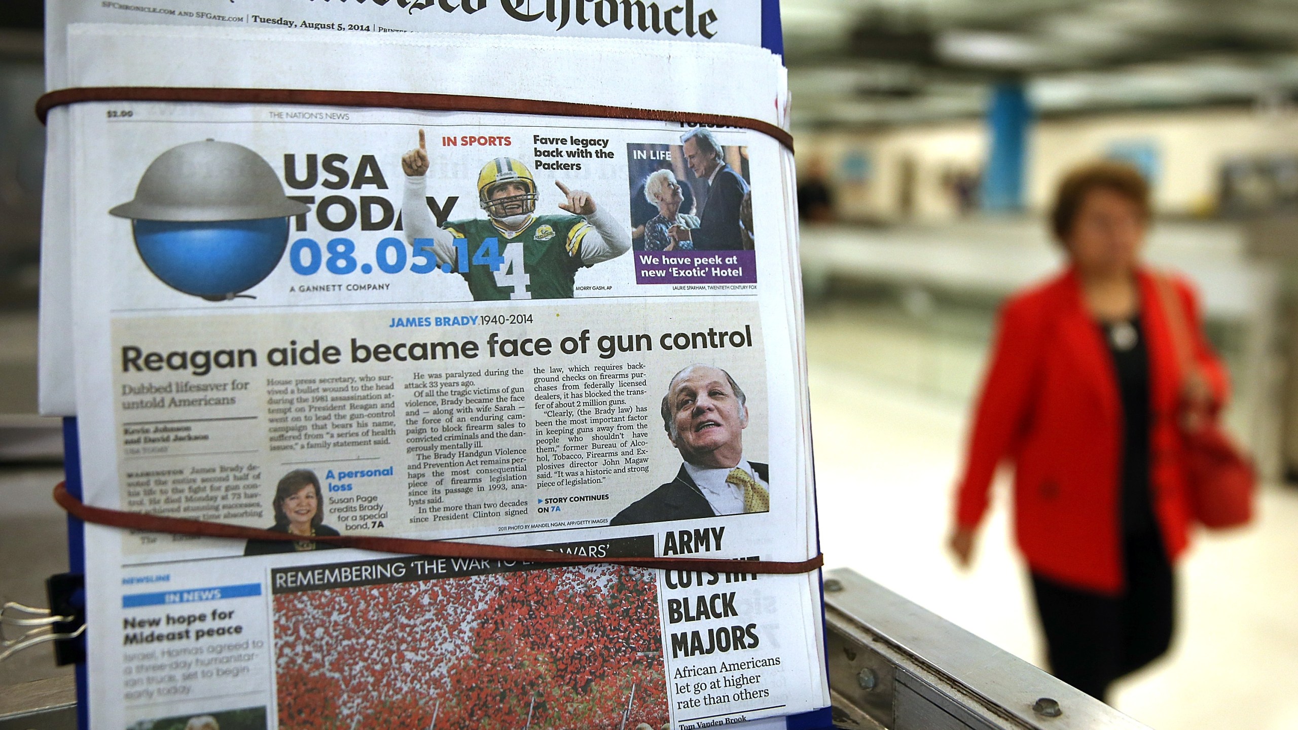 A copy of USA Today is displayed at a newsstand on Aug. 5, 2014, in San Francisco. USA Today owner Gannett Co. announced plans at the time to spin off its publishing business and create two publicly traded companies in order to separate its publishing division from its broadcasting and digital businesses. (Credit: Justin Sullivan/Getty Images)