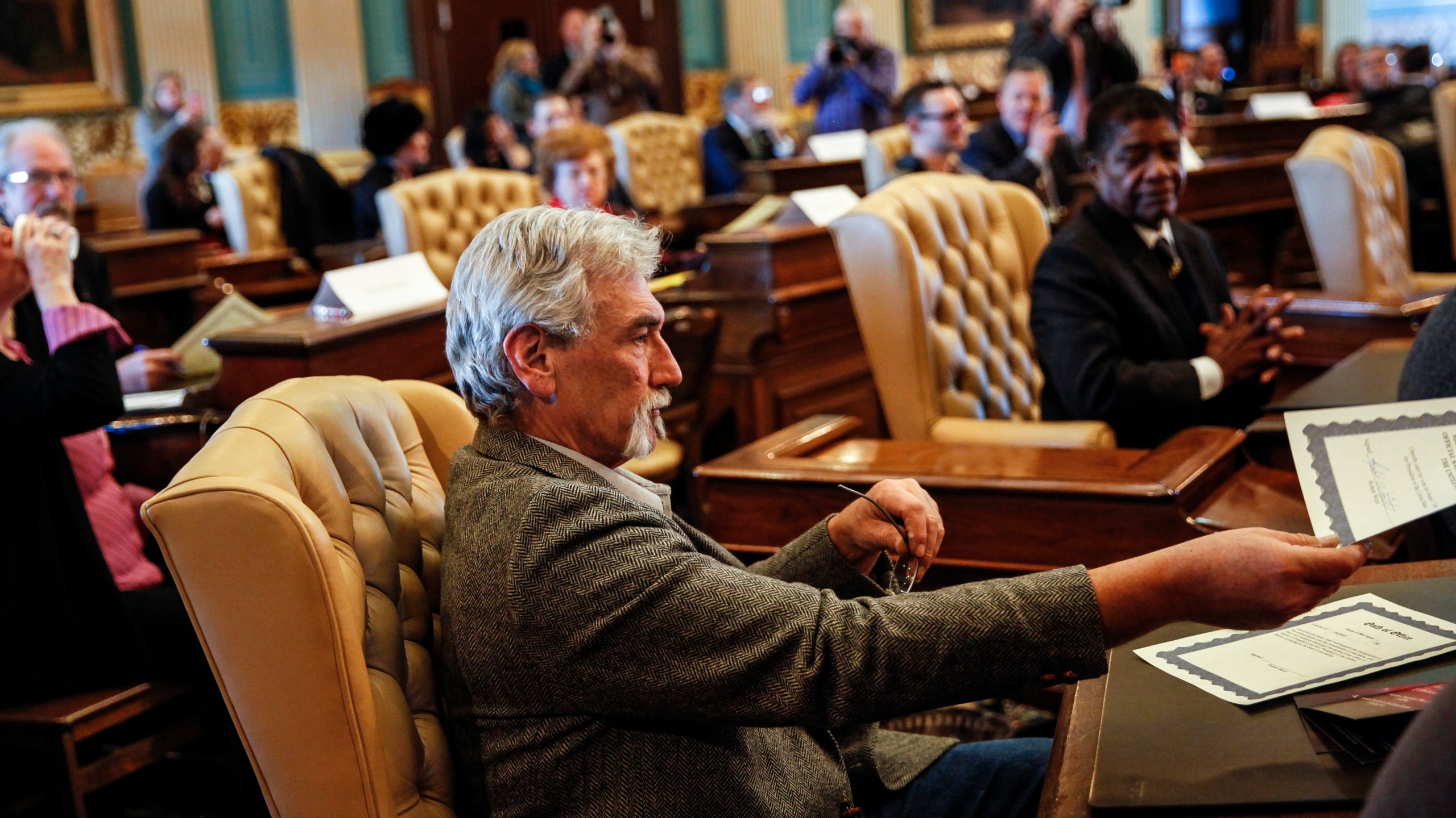 Robert Weitt, a Michigan representative to the Electoral College, hands in his signed vote for President-elect Donald Trump at the Michigan State Capitol on Dec. 19, 2016, in Lansing, Mich. (Credit: Sarah Rice/Getty Images)