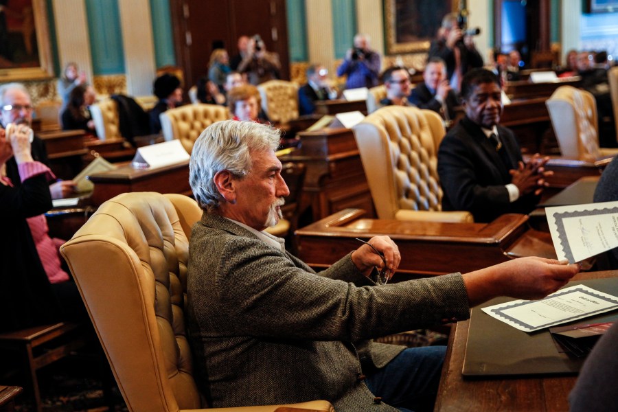 Robert Weitt, a Michigan representative to the Electoral College, hands in his signed vote for President-elect Donald Trump at the Michigan State Capitol on Dec. 19, 2016, in Lansing, Mich. (Credit: Sarah Rice/Getty Images)