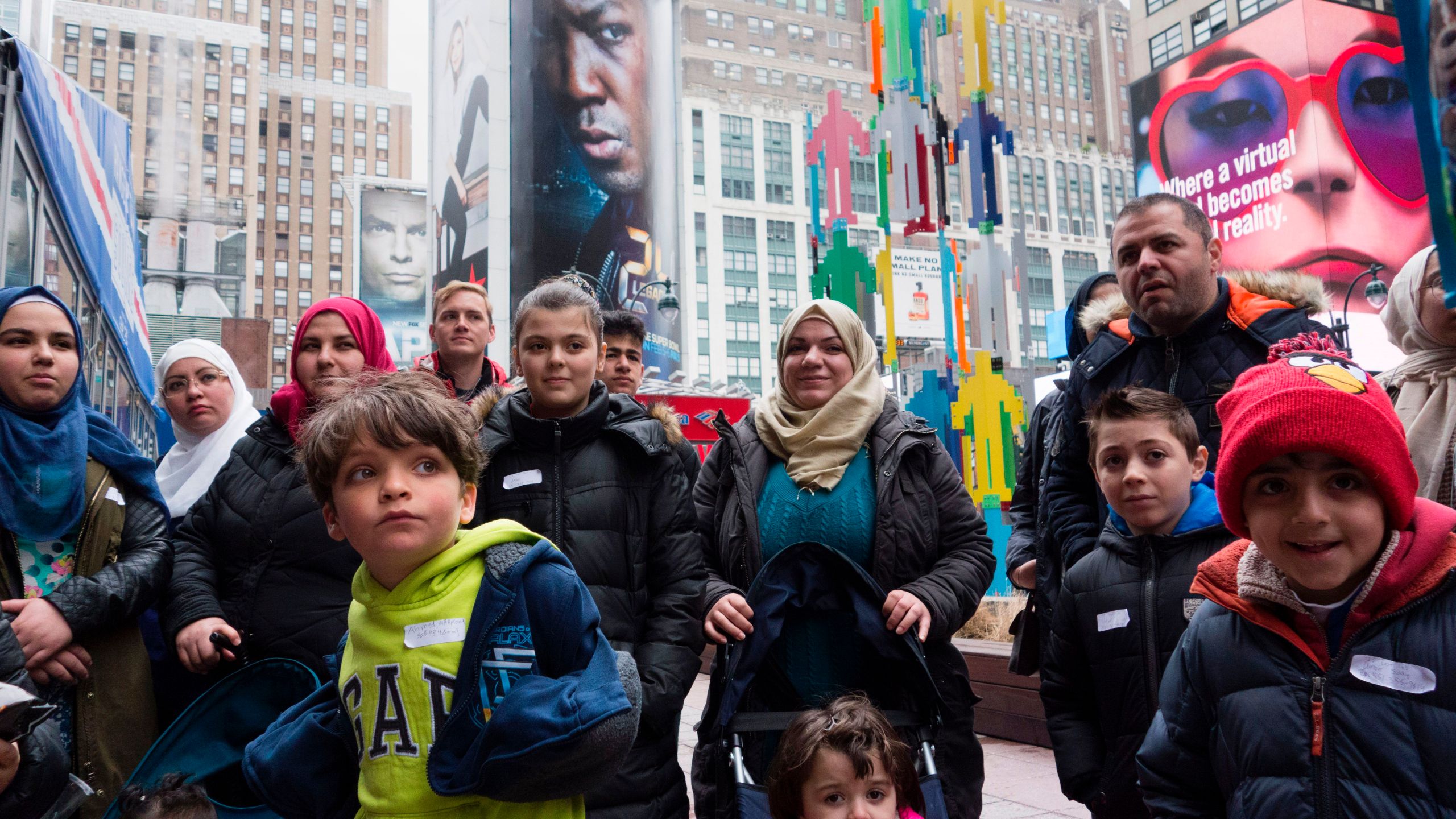 A group of Syrian and Iraqi refugee families gather outside Madison Square Garden for a tour of Manhattan on April 21, 2017, in New York City. (Credit: DON EMMERT/AFP/Getty Images)